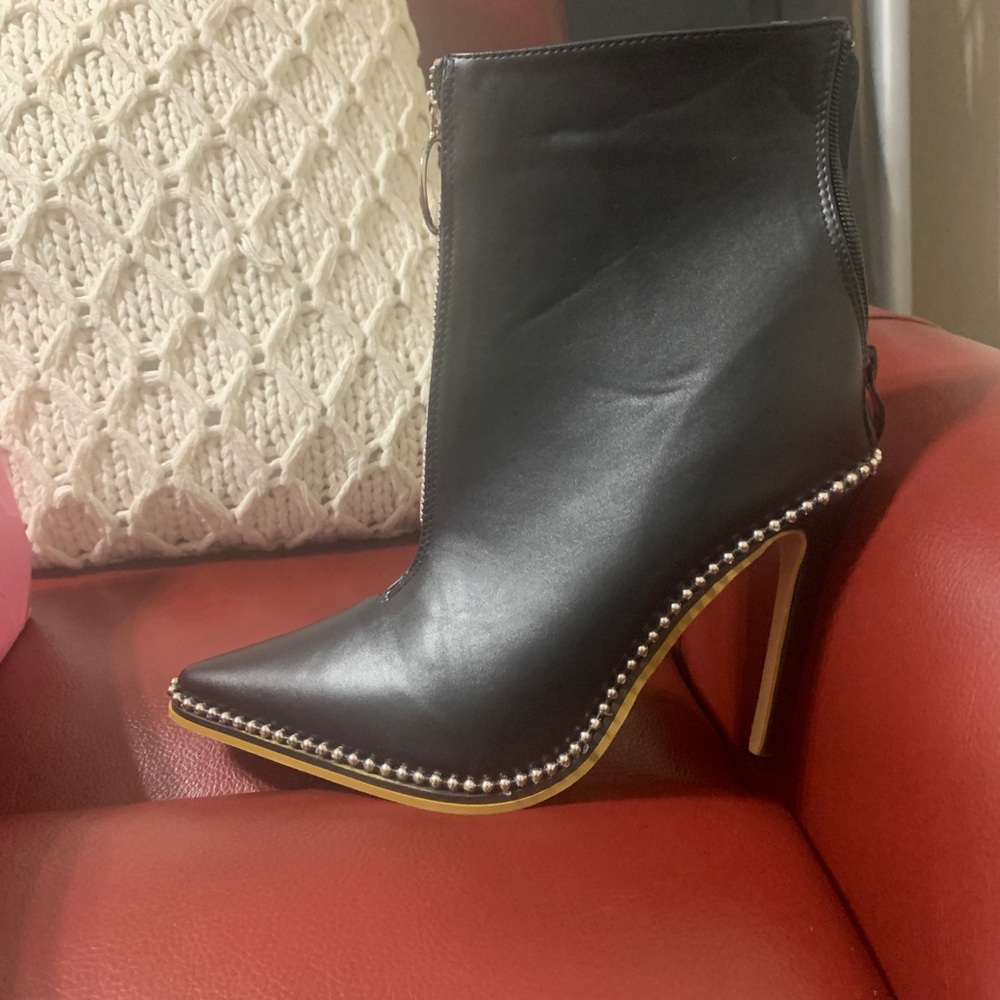 Black stud boots with zipper and stiletto heel.